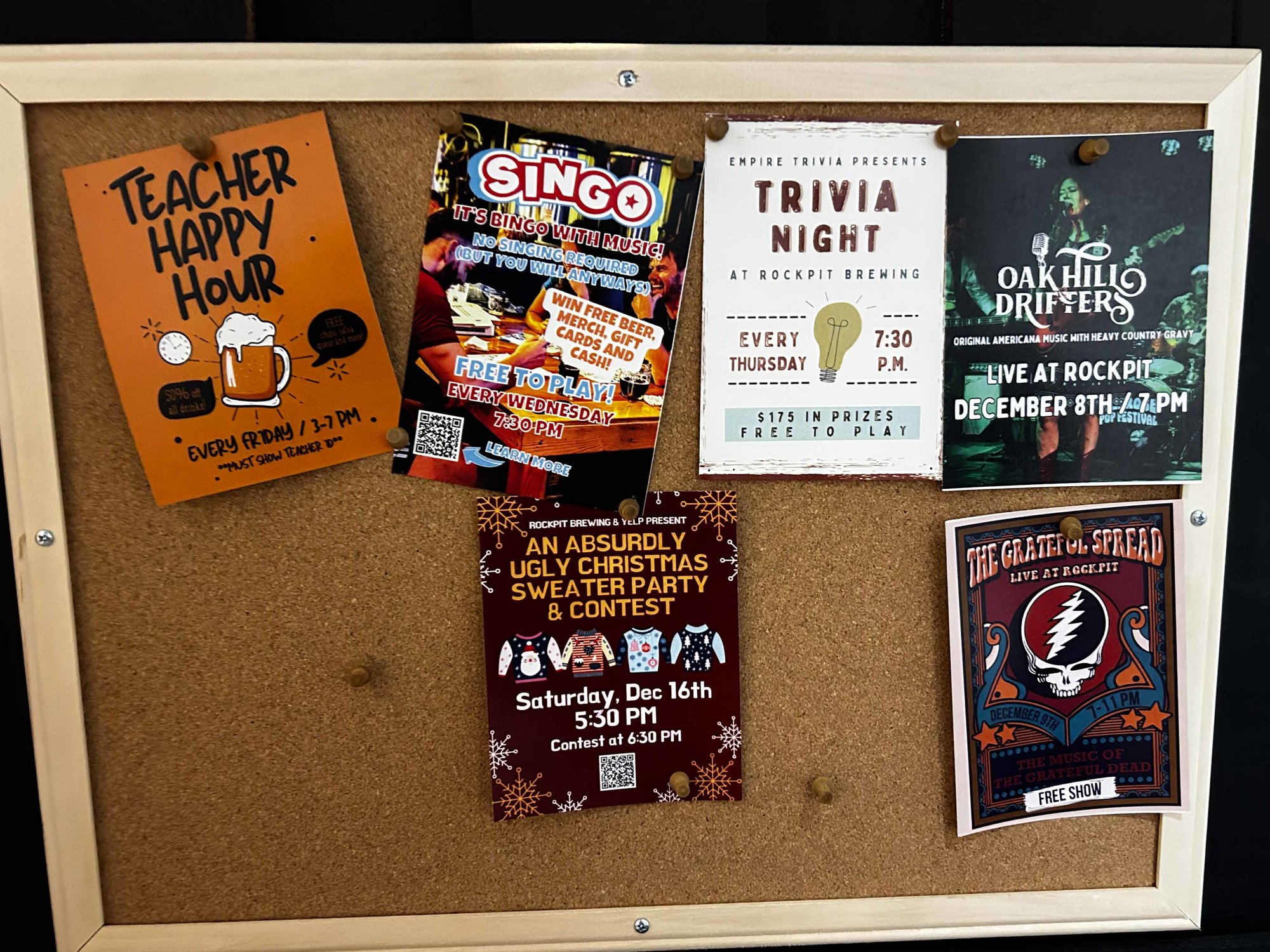cork board with fliers for various events